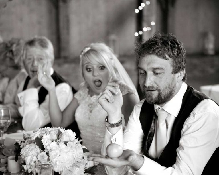 Bride and groom reacting to table magic